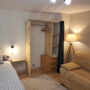 圣瑞尼安安塔迪奥旅馆的一间卧室配有衣柜、一张床和一张沙发