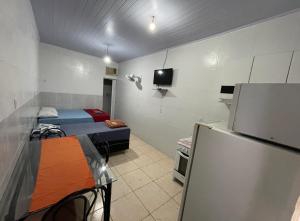 巴西利亚Hospedaria Cmc unidade 12的小房间设有两张床和一台冰箱