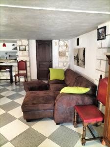 艾格-莫尔特Charmant appart avec extérieur的客厅配有棕色的沙发和椅子
