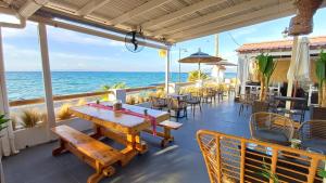 迈加洛丘里Hotel Beach Amaryllis的一个带桌椅的庭院和大海
