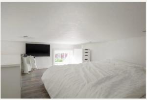 斯德哥尔摩Fresh happy little house, 35 m2 IN Täby的白色卧室配有床和平面电视