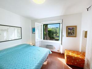 BagnaiaSant'Anna del Volterraio - Strada Maestra (56)的一间卧室设有蓝色的床和窗户。