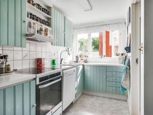 弗加尔巴卡Holiday Home Fjällbacka - BOH031 by Interhome的厨房配有绿色橱柜和水槽