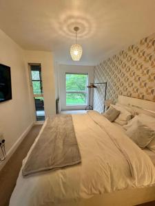 伦敦Cosy 1 Bed Apartment near Excel London的一间卧室设有一张大床和一个窗户。