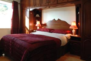 班克拉那Caldra B&B的一间卧室配有一张带两盏灯的大木床。