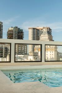 布宜诺斯艾利斯安再尼卡塔套房酒店 的一座带游泳池的建筑的 ⁇ 染
