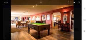 惠茨特布尔Crandley Manor Lodge的一间带台球桌和用餐室的房间