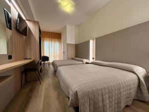 里米尼克巴尔托酒店的酒店客房配有两张床和一张书桌