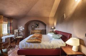 Albaretto Della Torre Villa Moglietta的一间卧室配有一张床和一张带台灯的桌子