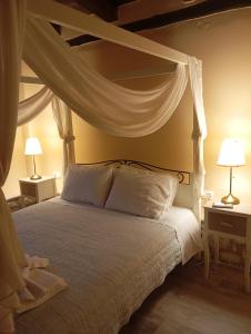 加瓦洛霍里翁La Villa "Casa di Lydia"的卧室配有带白色枕头的天蓬床