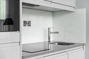 切姆Luxurious One Bedroom Apartment in Bond Street的厨房配有水槽和白色橱柜