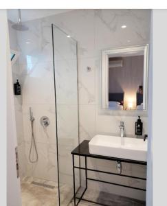 卡萨米尔GB Rooms的一间带水槽和玻璃淋浴的浴室