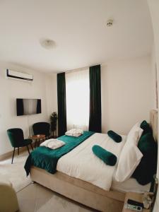 雅戈丁那Wing Nina2的一间卧室配有一张带绿色和白色床单的大床