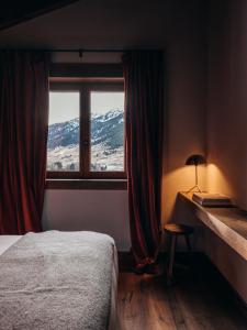卡尼略L´Ovella Negra Mountain Lodge的一间卧室设有一张床和一个美景窗户。
