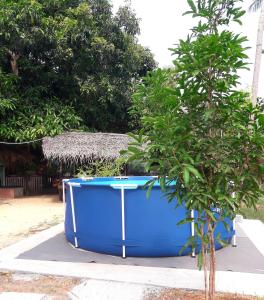 亭可马里Elena Garden Resort and Restaurant的一个大蓝色的浴缸,位于树旁