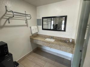 艾达Budget Inn Ada的一间带水槽和镜子的浴室