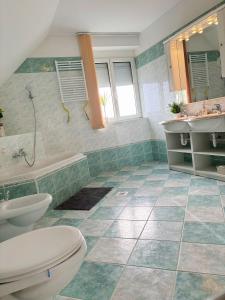 布达佩斯Garden villa的浴室配有卫生间、浴缸和水槽。