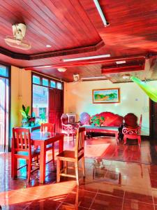 琅勃拉邦Tingkham Guesthouse的客厅配有桌椅和沙发