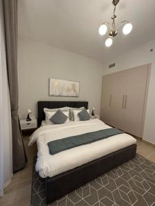 阿布扎比Elegant 1br With Partial Canal View At Yas Island的一间卧室配有一张大床和一个吊灯。