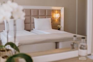 索非亚Impresamente Art Hotel的卧室配有白色的床和镜子