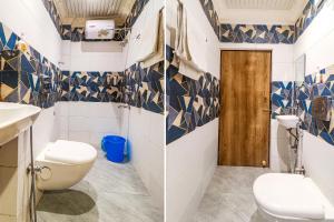 NaksalbāriFabHotel Roadside Inn的浴室拥有蓝色和白色的瓷砖墙壁,设有卫生间