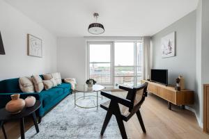 伦敦The Lambeth Apartment的客厅配有蓝色的沙发和电视