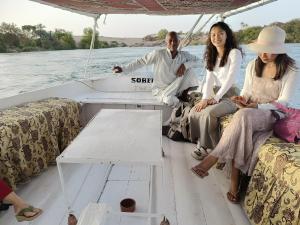 阿斯旺ABU Guest House的一群人坐在船的背面