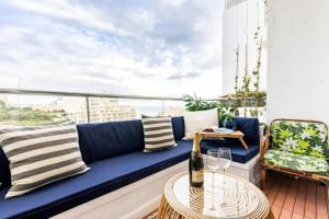 圣朱利安斯Seabreeze Retreat with terrace - St Julians的阳台的蓝色沙发,配有桌子