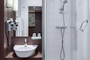 乌得勒支乌得勒支中心NH酒店的带淋浴、水槽和淋浴的浴室