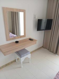 莫纳斯提尔梅兹里酒店的浴室设有镜子和一张桌子及凳子