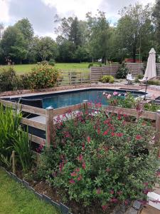 Le Mesnil-GarnierLe Val Daninière的花卉花园中的游泳池