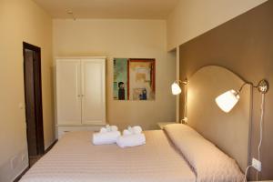 塔皮安诺Art Hotel Pandos的一间卧室配有带毛巾的床