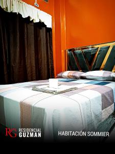 亚奎巴Residencial Guzmán 1的橙色客房的一张床位。