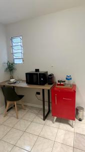 圣保罗Conforto e localização - São Paulo Expo的书桌、微波炉和红色冰箱
