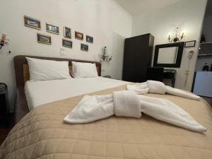 阿达玛斯Alice Maisonette & Studios的一间卧室配有两张床和白色毛巾。