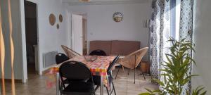 滨海阿热莱斯Charmant appartement de vacances的客厅配有餐桌和椅子