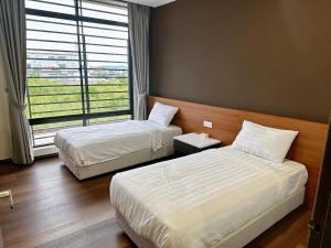 斗湖STAR HOTEL的配有窗户的酒店客房内的两张床