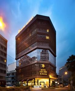 吉隆坡Izumi Hotel Bukit Bintang Kuala Lumpur的一座高大的建筑,上面有标志