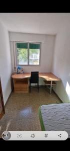 拉拉古纳Centro La Laguna Trinidad的一间卧室配有书桌、书桌和椅子