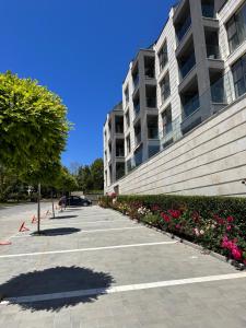 卡瓦尔纳ATEA Apartments的鲜花盛开的建筑前的停车场