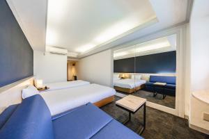 东京L stay＆grow晴海的酒店客房,设有两张床和一张沙发