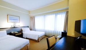 香港南洋酒店的酒店客房设有两张床和一台平面电视。