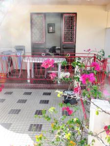 法兰西堡Appartement d'une chambre avec balcon amenage et wifi a Fort de France a 2 km de la plage的庭院里种有粉红色的鲜花,配有桌椅