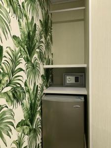 圣安德烈斯WH HOTEL的厨房里配有冰箱,铺有热带壁纸