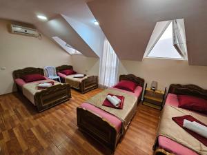 乌雷基Imeri Hotel的阁楼间设有三张床和一扇窗户。