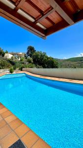 梅桑弗里乌Private Douro- Quinta das Susandas的屋顶下的大型蓝色游泳池