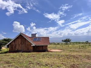 Oloitokitok Kilimanjaro view cabin-Amboseli的一座带太阳能屋顶的旧谷仓