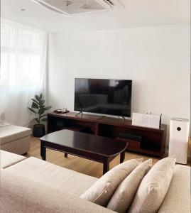 清迈Sense of Haiya的一间带电视和沙发的客厅