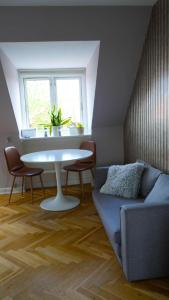 哥本哈根Cosy room in residential part of Copenhagen, with free street parking and shared bathroom的带沙发、桌子和窗户的客厅