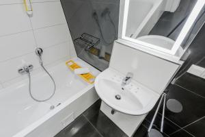 沃尔姆斯Nibelungen Apartments的白色的浴室设有水槽和淋浴。